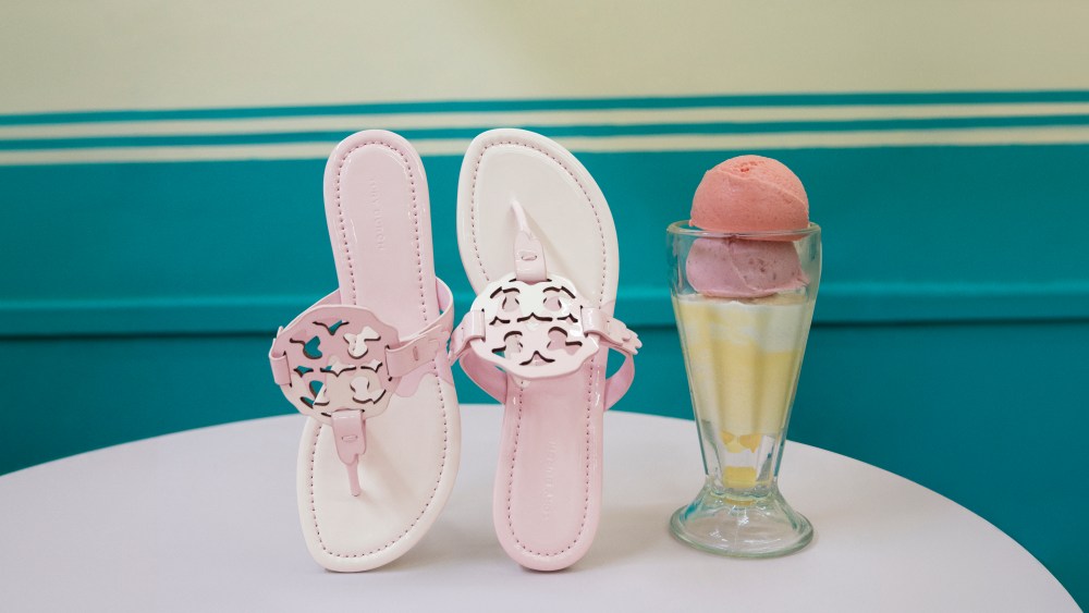 tory burch miller sandals in pink on table next to ice cream in glass from fashion campaign