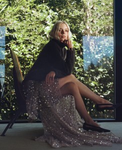 Louis Vuitton wool and cotton pleat waist turtleneck pullover and silk and cotton skirt; Carven napa leather heels; Jaeger-LeCoultre Reverso Tribute Small Seconds; Jean Schlumberger by Tiffany & Co. ring in yellow gold and platinum with an unenhanced purple sapphire and diamonds.