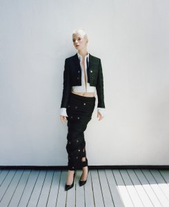 Thom Browne wool cropped jacket with quilted oxford in hunting tartan, cotton quilted oxford, wool crepe low-rise ankle-length hobble skirt and cotton bow tie; Jaeger-LeCoultre Reverso One Duetto; Jean Schlumberger by Tiffany Apollo ear clips in gold with diamonds in platinum.