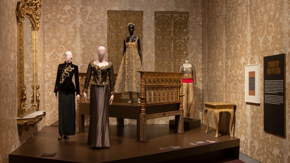 YVES SAINT LAURENT, Paris, France, founded 1961 YVES SAINT LAURENT, French, born Algeria, 1936–2008, Evening Ensemble, Haute Couture collection Fall/Winter 1995 –96, Embroidered black velvet jacket ; black satin skirt; earrings; velvet pumps Musée Yves Saint Laurent, Paris. YVES SAINT LAURENT Paris, France, founded 1961, YVES SAINT LAURENT French, born Algeria, 1936–2008 Ensemble, Ready-to-Wear collection, Fall/Winter 1996–97, Black and gold reptile-print leather tunic with arabesque patterns embroidered with gold sequins and beads, white rhinestone cabochons, and teardrops; silver satin viscose skirt; black satin ankle boots, Musée Yves Saint Laurent, Paris, and CHRISTIAN DIOR, Paris, France, founded 1946, MARIA GRAZIA CHIURI, Creative director, Italian, born 1964 Numéro 352 (also known as Miss Dior), Haute Couture collection, Spring/Summer 2021,Gold silk dress embroidered with lattice of handmade gold flowers and petal motifs; gold openwork leather boots; brass rings; pearl, necklace with golden brass floral medallion; gold metal tiara with pearls, Dior Héritage collection, Paris , inv. 2021.2298, and CHRISTIAN DIOR Paris, France, founded 1946 GIANFRANCO FERRÉ Artistic director (1989–96), Italian, 1944–2007 Hélios, from Summer Impressions Haute Couture collection Spring/Summer 1993 Jacket with gold bugle bead , sequin , and glitter embroidery and gilded leaves; belt inlaid with vermilion bugle beads; trousers with white - and gold-painted sequin embroidery and gold papier cinétique overlay Dior Héritage collection, Paris , inv. 1993.26, Gianfranco Ferré’s Summer Impressions collection comprised seventy-nine creations presented in three sections: “In the Eye of the Sun,” “Summer Fires,” and “Gallant Parties.” In his notes, Ferré stated, “The morning sun rises from amidst trembling foliage, like a premonition of silhouette.” Evoking imagery of being exposed to the sun’s intensity, he continued “At the hour when dawn grows, long and slender silhouettes appear in an almost diaphanous whiteness.” Ferré’s Hélios ensemble is named after the Greek sun god, who rises from the ocean every morning and sets in a blaze of color each evening.