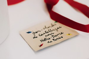 A tag for the Jean-Charles de Castelbajac for Notre-Dame de Paris garments.