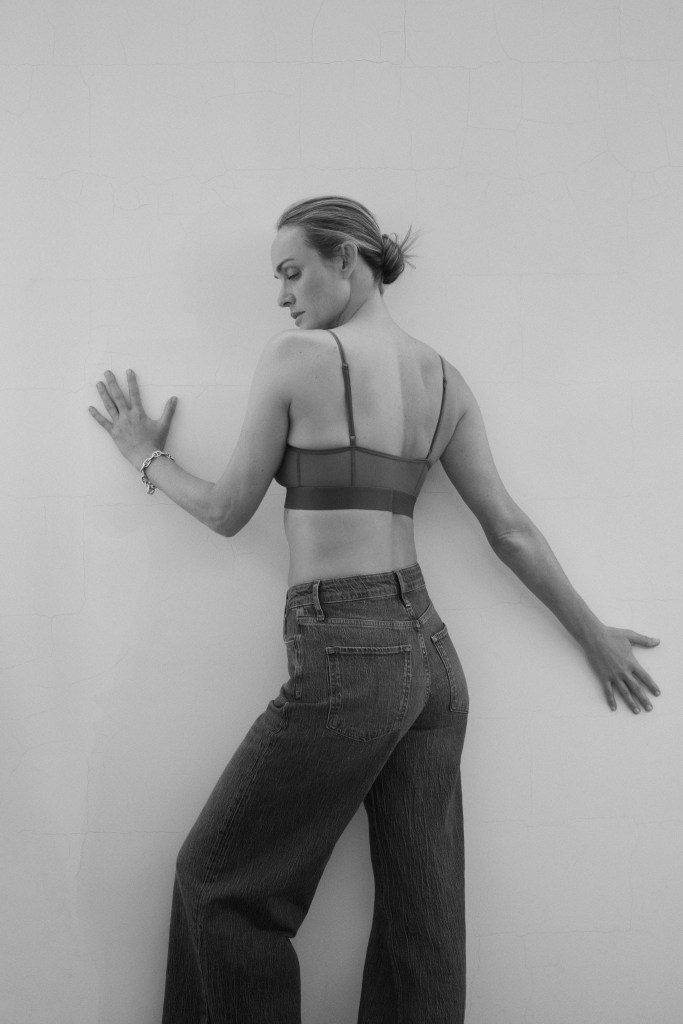 
Amber Valletta poses in Triarchy's plastic-free stretch denim as part of her curated edit.  