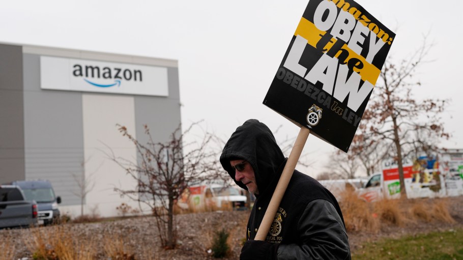 A striker holds a sign during a strike at an Amazon delivery station in Skokie, Ill., Thursday, Dec. 19, 2024.