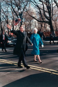 George Bush smiles and waves onlookers as he and Barbara walk down a street on his inauguration day. Washington D.C., January 20, 1989.