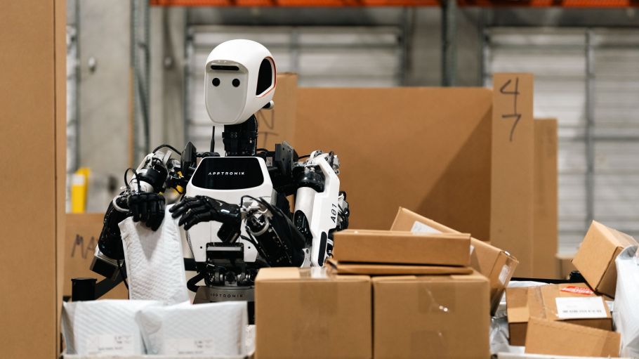 An Apptronik humanoid robot works in a warehouse.