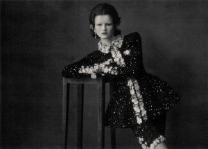 Chanel haute couture sequined tweed peplum jacket and Bermuda shorts painted with white, embellished with taffeta floral braid and jeweled buttons, velvet and gold metal belt. Chanel High Jewelry Lion Solaire de Chanel earrings in 18-karat white gold with diamonds.