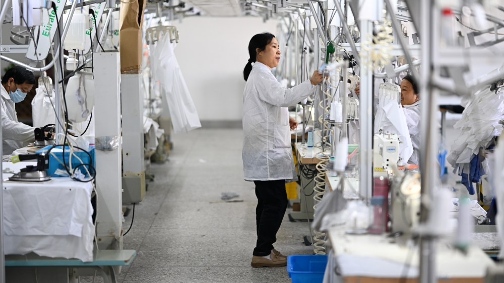 A worker produces shirts on an assembly line at a garment factory in China.