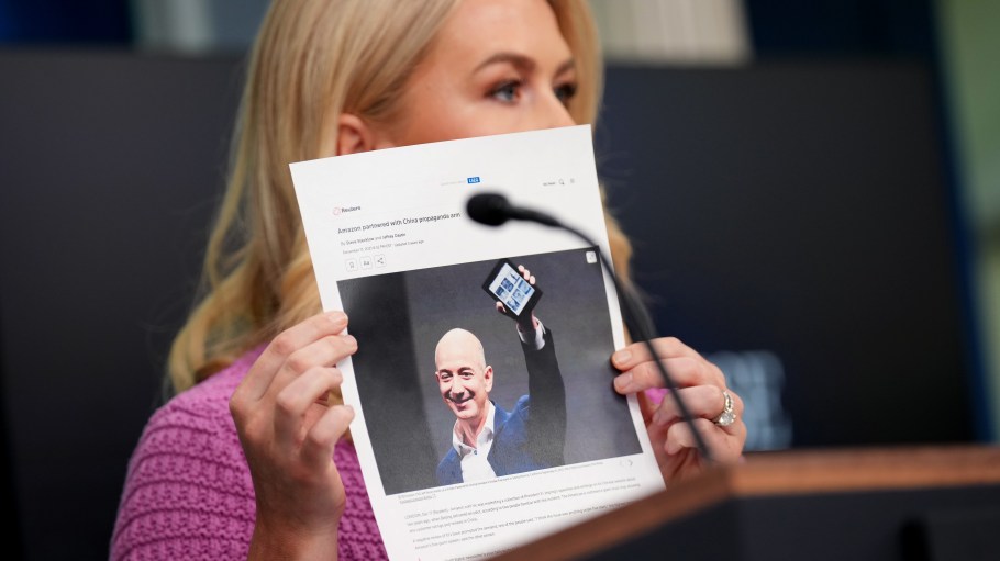 WASHINGTON, DC - APRIL 29: Karoline Leavitt, White House press secretary, holds a news article on Amazon CEO Jeff Bezos as she speaks during the daily press briefing.