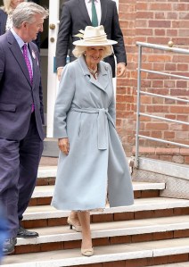 YORK, ENGLAND - AUGUST 21: Queen Camilla smiles with Vice Lord Lieutenant of North Yorkshire, Chris Legard (L) as she arrives for day two of the Ebor Festival at York Racecourse on August 21, 2025 in York, England.  (Photo by Ian Forsyth/Getty Images)