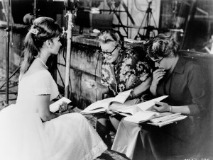 Italian actress Sophia Loren studies with her tutors on the set of the film 'The Millionairess', circa 1960.
