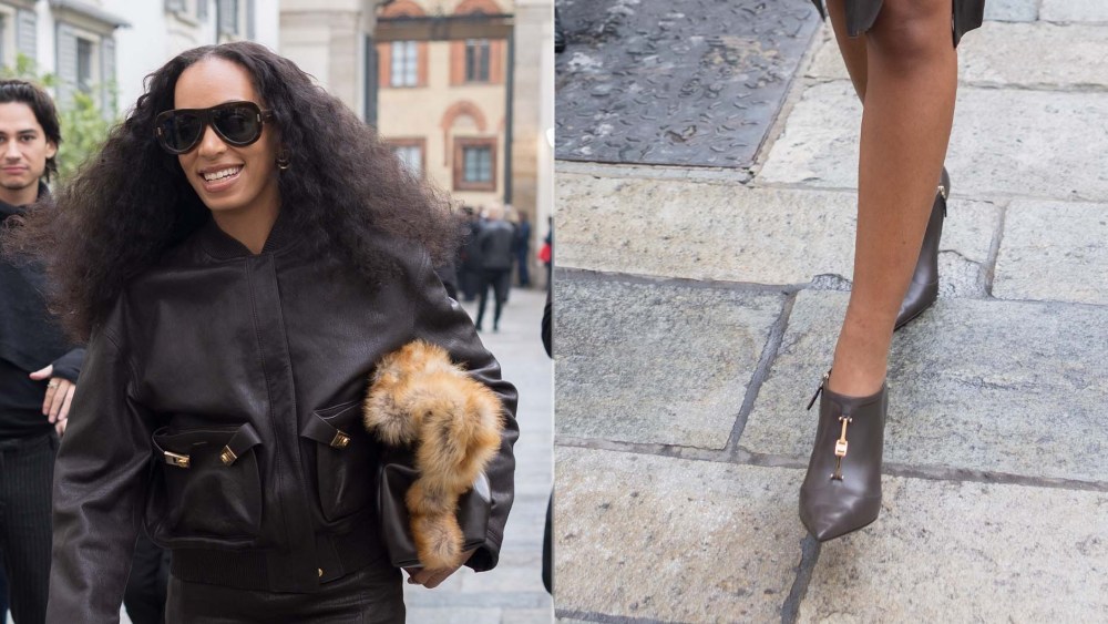 Solange Knowles at Ferragamo during Milan Fashion Week on Saturday wearing black booties with gold hardware detailing.