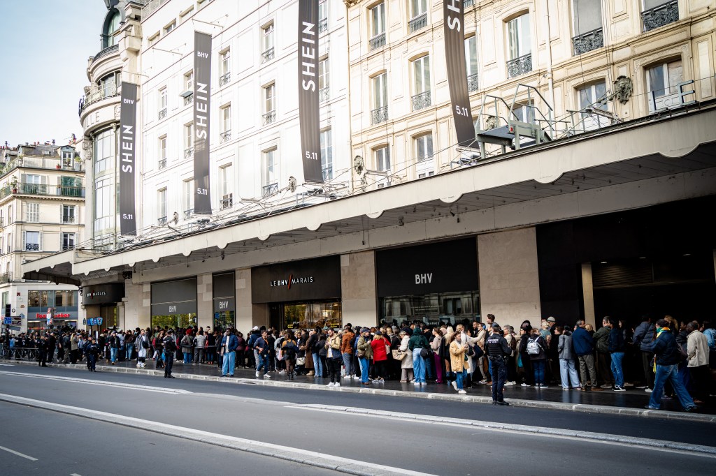 Many customers queue up on the pavement to enter the shop, Opening of a corner shop for Chinese brand Shein, a fast fashion specialist (clothing, low-cost products with a high environmental impact), accused of selling sex dolls with child pornography featuring children s faces (child criminality, child pornography) and of employing child labour in Paris, France on November 5, 2025. The atmosphere between the first customers waiting to enter and the protesters and actions against Shein, illustrating the society of overconsumption and its opponents. (Photo by Amaury Cornu / Hans Lucas via AFP) (Photo by AMAURY CORNU/Hans Lucas/AFP via Getty Images)