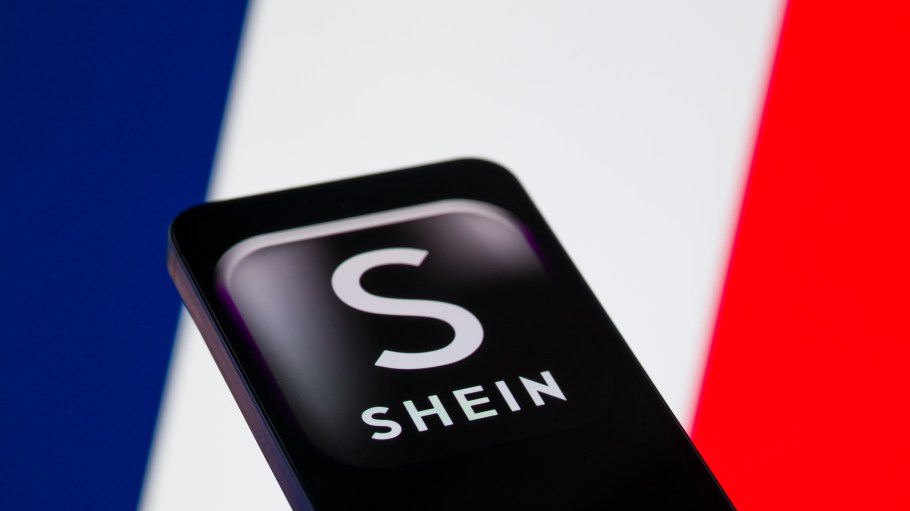 The Shein logo is displayed on a mobile phone with the flag of France in the background, in this photo illustration in Brussels, Belgium, on November 8, 2025. (Photo by Jonathan Raa/NurPhoto via Getty Images)