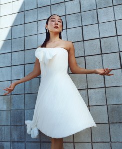 Dior draped dress with bow and shoes; Tiffany & Co. Bird on a Rock by Tiffany Wings drop diamond earrings in platinum.