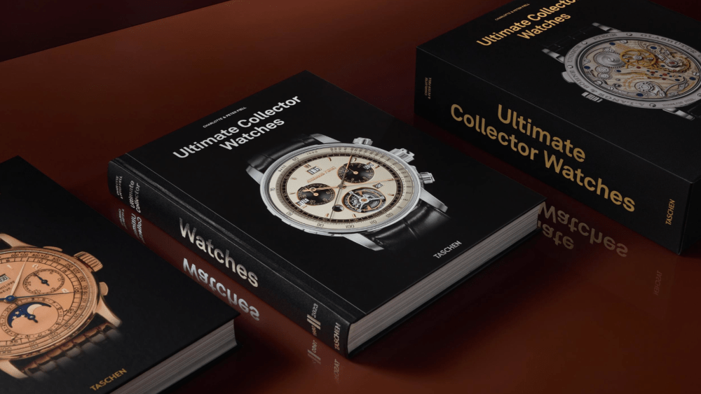 multiple "ultimate collector watches" books resting on a glossy, table-like surface