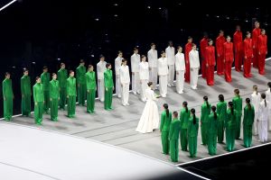 Vittoria Ceretti, flagbearer for Milano, carries the Italian flag during the opening ceremony of the Milano Cortina 2026 Winter Olympics.