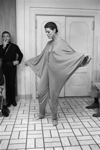 Model wearing v-neck batwing jumpsuit from the Rudi Gernreich resort 1969 collection shown in New York. Gernreich watches in the background.