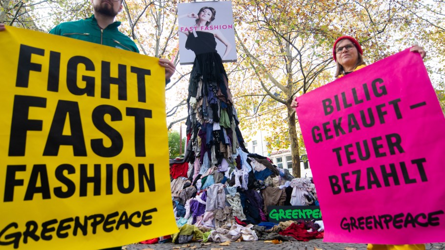 Activists near a ''fight fast fashion'' art installation in Germany.