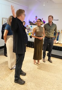 MELBOURNE, AUSTRALIA - APRIL 14: Prince Harry, Duke of Sussex and Meghan, Duchess of Sussex are shown artwork by army reservist Keith Ross (2nd L) at the Australian National Veterans Arts Museum (Anvam) in Southbank on April 14, 2026 in Melbourne, Australia. Meghan and Prince Harry, Duke of Sussex are on a four-day visit to Australia, with engagements across Melbourne, Canberra and Sydney. (Photo by Jonathan Brady-Pool/Getty Images)