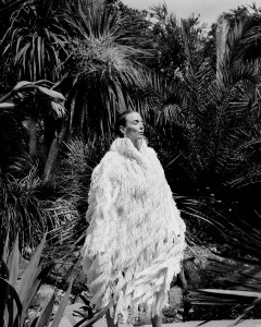 Alaïa cotton coat with embroidered silk fringes and patent calfskin leather sandals; Bulgari 18-karat yellow gold Vimini earrings.