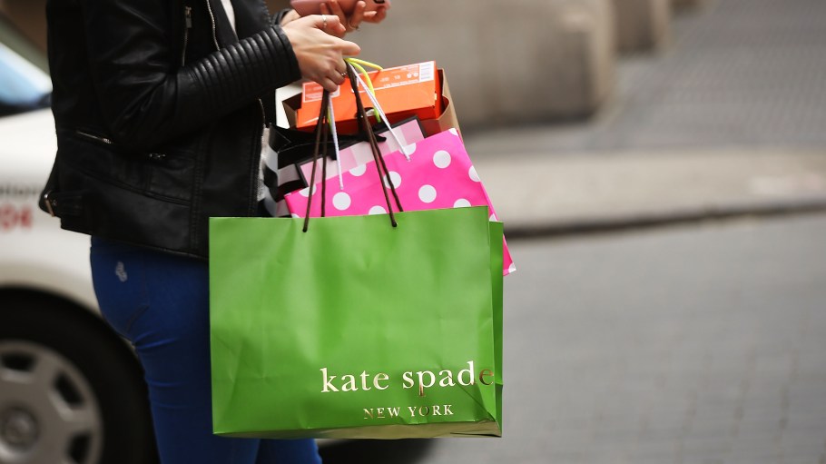 NEW YORK, NY - MAY 08:  A woman walks out of a Kate Spade store in the SoHo neighborhood of Manhattan on May 8, 2017 in New York City. Coach, the American maker of high-end luxury goods, announced on Monday that it would buy rival Kate Spade in a $2.4 billion deal.  (Photo by Spencer Platt/Getty Images)